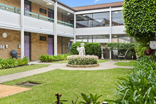 two residential aged care residents socialising in the gardens of baptistcare aminya centre aged care home