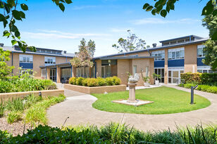 beautiful large gardens at the entrance of baptistcare shalom centre modern aged care home providing low level care and dementia care for aged care residents in macquarie park nsw