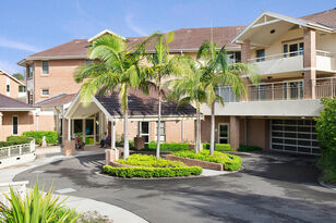 baptistcare warena centre modern aged care home with long driveway and footpath lined with beautiful gardens in bangor aged care in sutherland shire nsw