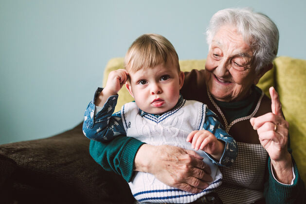aged care resident enjoying time with grandson in nursing home